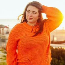 Woman in Orange Jumper