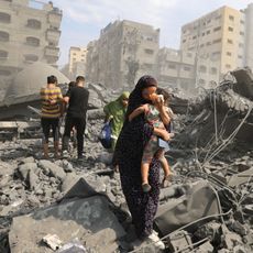 Palestinians evacuate the area following an Israeli airstrike on the Sousi mosque in Gaza City on October 9, 2023. Israel continued to battle Hamas fighters on October 9 and massed tens of thousands of troops and heavy armour around the Gaza Strip after vowing a massive blow over the Palestinian militants' surprise attack.