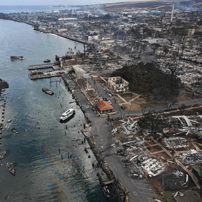 An aerial image taken on August 10, 2023 shows destroyed homes and buildings burned to the ground in the historic Lahaina in the aftermath of wildfires in western Maui in Lahaina, Hawaii. At least 36 people have died after a fast-moving wildfire turned Lahaina to ashes, officials said August 9, 2023 as visitors asked to leave the island of Maui found themselves stranded at the airport. The fires began burning early August 8, scorching thousands of acres and putting homes, businesses and 35,000 lives at risk on Maui, the Hawaii Emergency Management Agency said in a statement. 